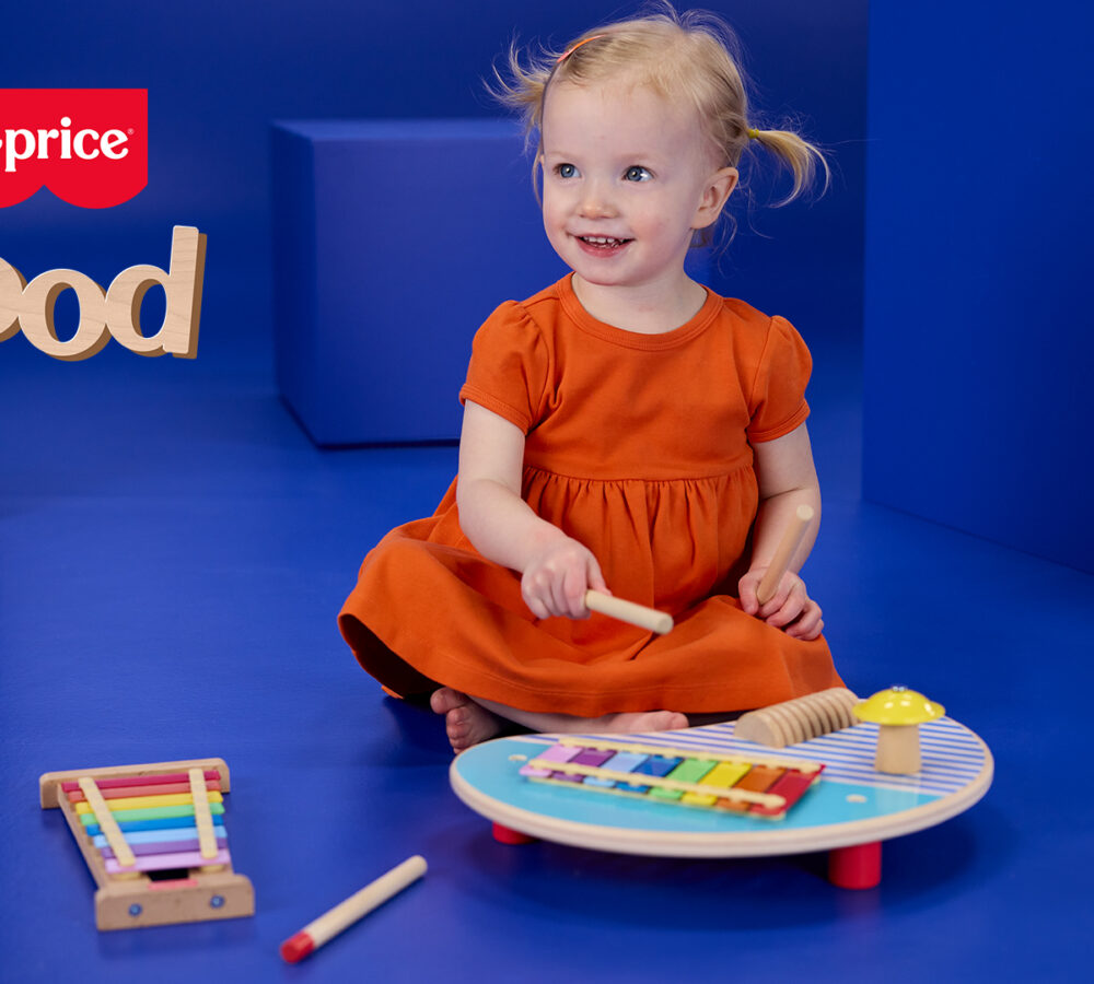 Child playing with Fisher Price new wooden toy range