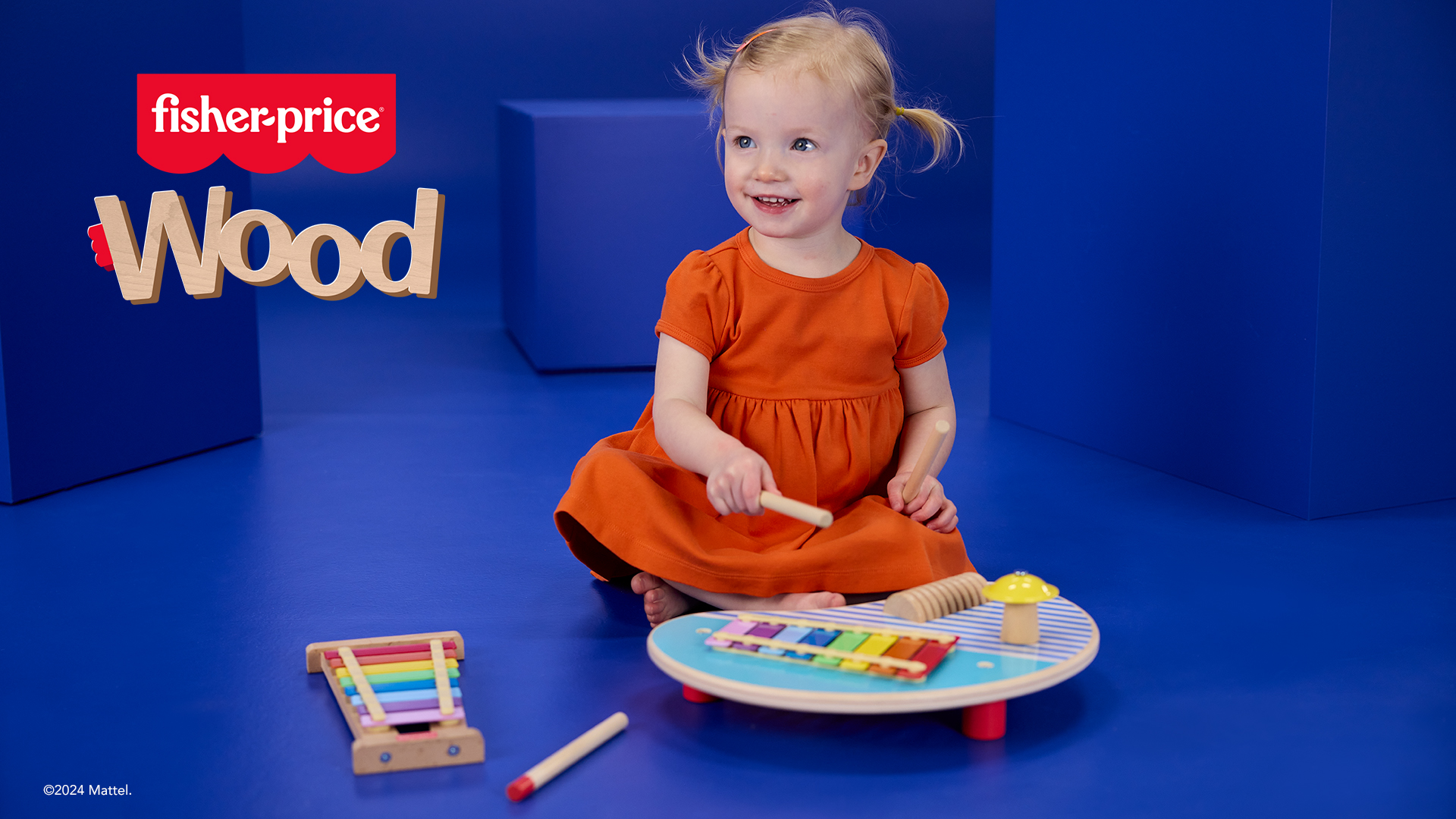 Child playing with Fisher Price new wooden toy range